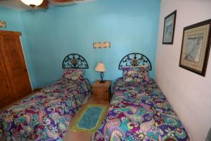 two beds sitting next to each other in a bedroom at 3-bedroom Poolside San Felipe Vacation villa in La Ponderosa