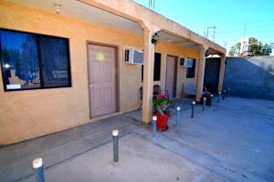 a building with a porch with a door and a plant at San Felipe Rental Studio 3 FREE WIFI AND CABLE TV in San Felipe