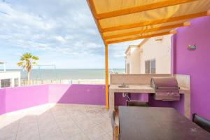 a purple building with a grill and the beach at Condo 5, in San Felipe Just Steps to the Beach, Near the Malecon. in San Felipe