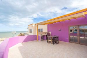 a purple house with a table and chairs on a balcony at Condo 5, in San Felipe Just Steps to the Beach, Near the Malecon. in San Felipe +26 photos