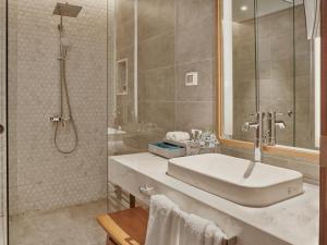 a bathroom with a sink and a shower at Mercure Vung Tau Resort in Vung Tau +127 photos