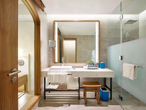 a bathroom with a sink and a mirror at Mercure Vung Tau Resort in Vung Tau