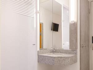 a bathroom with a sink and a mirror at ibis budget Barranquilla in Barranquilla