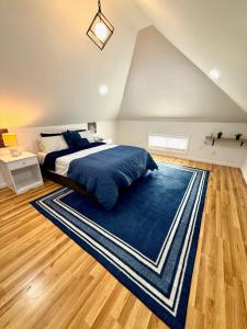 a bedroom with a bed and a blue rug at NYC-Style Loft with Secret Entrance - Just 6 Miles from Times Square in North Bergen