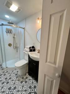 a bathroom with a shower and a toilet and a sink at NYC-Style Loft with Secret Entrance - Just 6 Miles from Times Square in North Bergen