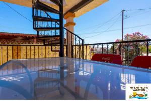 a swimming pool with two red chairs on a balcony at Casa Sirena del Mar San Felipe Rental Home in San Felipe