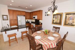 a kitchen and dining room with a table and chairs at El Dorado Ranch Vacation Rental Condo 25-1 | 18-Hole Golf in Playa El Paraíso