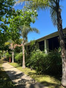 a house with palm trees in front of it at PATO NEGRO in Tigre