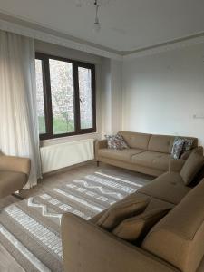 a living room with a couch and a window at House overlooking a lake 