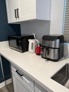a kitchen counter with a microwave and a coffee maker at Guesthouse in Hewitt +4 photos