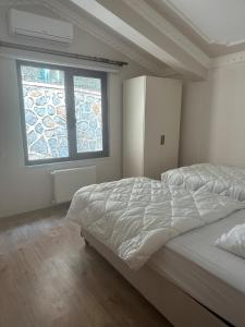 a bedroom with a large bed and two windows at House overlooking a lake  +29 photos