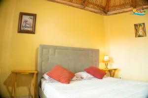 a bedroom with a bed with orange and white pillows at 1-Bedroom Beach Studio - Serene getaways. in San Felipe