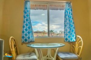 a table and chairs in front of a window at 1-Bedroom Beach Studio - Serene getaways. in San Felipe