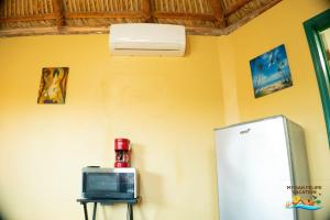 a room with a refrigerator and a tv at 1-Bedroom Beach Studio - Serene getaways. in San Felipe