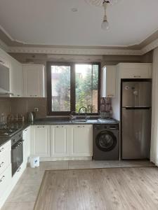 a kitchen with white cabinets and a sink and a dishwasher at House overlooking a lake 