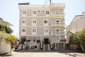 a large white building with a lot of windows at Hotel Floga in Shkodër