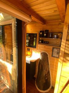 an outside view of a cabin with a table and chair at Casa del Árbol Sesquile in Tres Esquinas