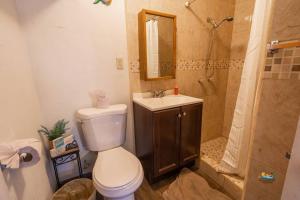 a bathroom with a toilet and a sink and a shower at Huge Family 5 bedroom sleeps 16 with private pool home in San Felipe