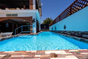 a large swimming pool with blue water at Huge Family 5 bedroom sleeps 16 with private pool home in San Felipe