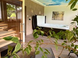 a bedroom with a bed and a tub in it at Ober Langengarten in Pittenbach