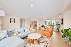 a living room with a couch and a table at The Drift at Cathie in Lake Cathie