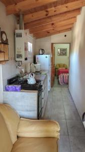 a kitchen with a stove and a refrigerator at Casa de Nancy y Carlos in Juana Koslay 