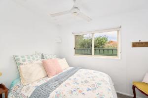 a bedroom with a bed and a window at The Drift at Cathie in Lake Cathie +15 photos