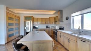 a kitchen with wooden cabinets and a counter top at Amazing El Dorado Ranch Pool house La Kasa 53 in Playa El Paraíso