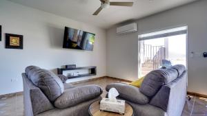 a living room with two couches and a tv at Amazing El Dorado Ranch Pool house La Kasa 53 in Playa El Paraíso