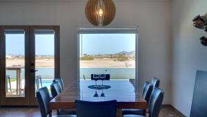 a dining room with a table and chairs with a view at Amazing El Dorado Ranch Pool house La Kasa 53 in Playa El Paraíso