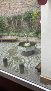 a statue of a bird sitting in a fountain at Gasthaus Liam 2 in Bendorf +1 photo
