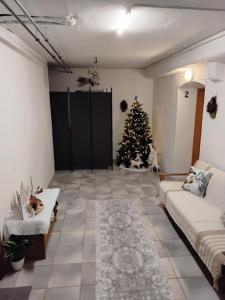 a living room with a christmas tree and a couch at Alpine's Apartment in Arnoldstein +13 photos