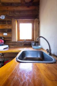 a sink in a kitchen with a window at Cabañas rainbow in San Marcos Sierras