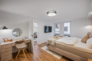 a bedroom with a bed and a desk and a mirror at Exklusive City Apartments in Bad Kissingen