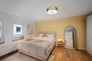 a bedroom with a bed with two towels on it at Exklusive City Apartments in Bad Kissingen