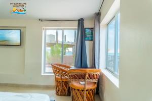 a room with a chair in front of a window at Rancho Percebu Beach Studio 4 in San Felipe