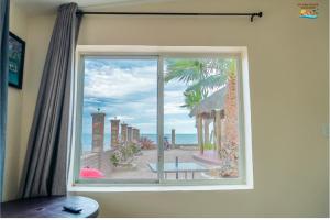 a window in a room with a view of the beach at Rancho Percebu Beach Studio 4 in San Felipe