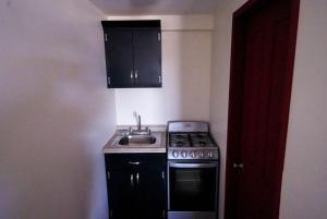 a small kitchen with a stove and a sink at Rancho Percebu Beach Studio 4 in San Felipe +24 photos