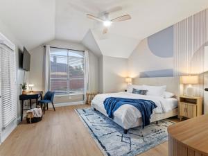 a bedroom with a bed and a desk and a window at Boho Dreamscape 4BD Game Room Pool in The Colony +47 photos