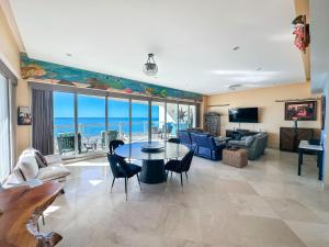 a living room with a view of the ocean at Waves & Relaxation Oceanfront 2BR Family Condo in Puerto Peñasco