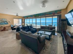 a living room with a view of the ocean at Waves & Relaxation Oceanfront 2BR Family Condo in Puerto Peñasco