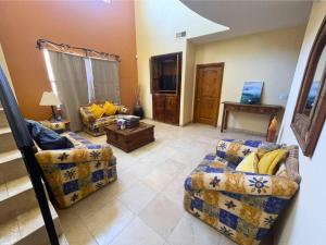 a living room with two couches and a tv at San Felipe Luxurious 3-Bedroom Condo 11-3 with Pool Access in La Ponderosa