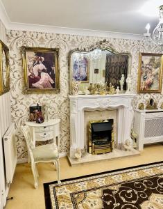 a living room with a fireplace and a mirror at Themed Cosy Home by Cannock Chase Forest in Rugeley