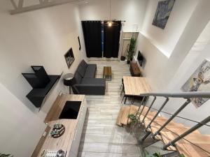 a loft living room with a couch and tables at Duplex Moon x4 pers NEW - Gare Parilly in Vénissieux