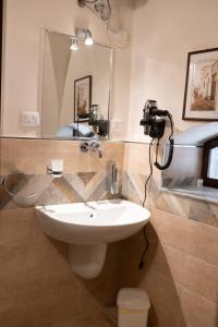a bathroom with a sink and a mirror and a camera at L'Alcova dei Grifoni in Ascoli Satriano +19 photos