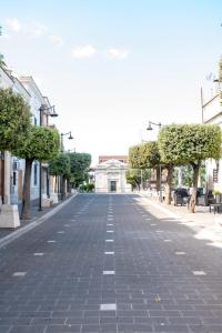 a cobblestone street with trees and a building at L'Alcova dei Grifoni in Ascoli Satriano