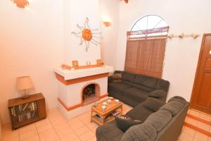 a living room with a couch and a fireplace at Casa Rubio del Mar - Monthly Rentals Welcome in San Felipe