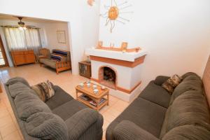 a living room with a couch and a fireplace at Casa Rubio del Mar - Monthly Rentals Welcome in San Felipe