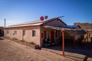 a small house with a straw roof on a brick road at 3 bedroom Beach side home away from home in San Felipe