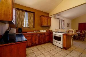 a kitchen with wooden cabinets and a white stove top oven at 3 bedroom Beach side home away from home in San Felipe